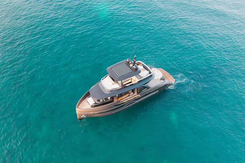 Explocean 3 Yacht Photos Pics Aerial view of 2025 Explorer 62 yacht cruising in clear blue ocean waters.