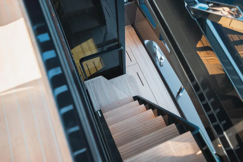 Explocean 3 Yacht Photos Pics Staircase on 2025 Explorer 62 yacht, featuring sleek wooden design and modern aesthetics.