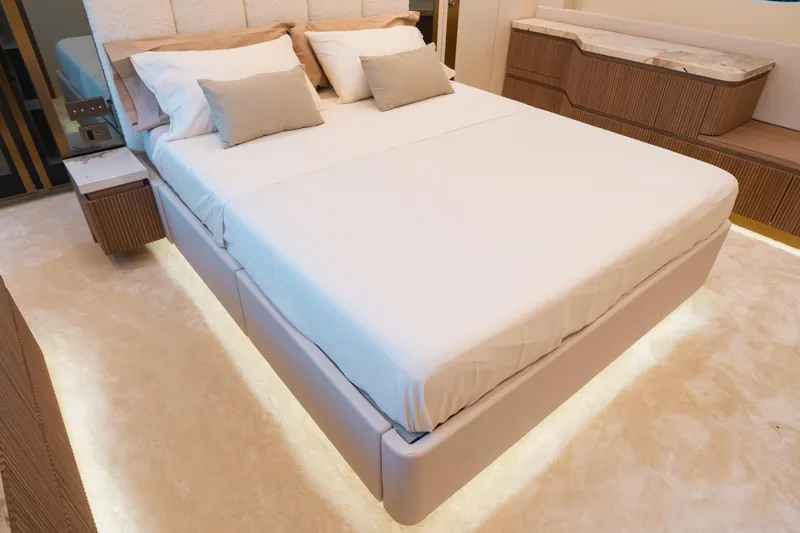 Explocean 3 Yacht Photos Pics Luxurious bedroom interior in 2025 Explorer 62 yacht, featuring elegant bed and ambient lighting.