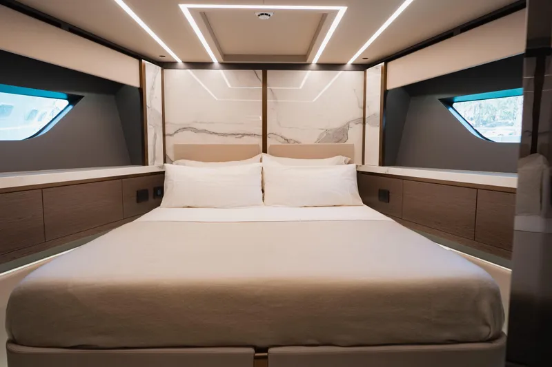 Explocean 3 Yacht Photos Pics Luxurious bedroom interior of 2025 Explorer 62 yacht with modern design and ambient lighting.