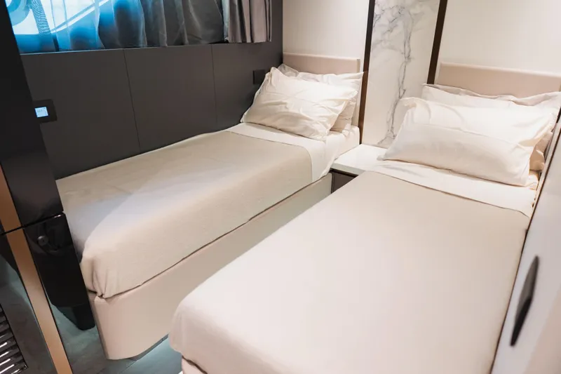 Explocean 3 Yacht Photos Pics Luxurious twin beds in 2025 Explorer 62 yacht cabin, featuring modern design and comfort.