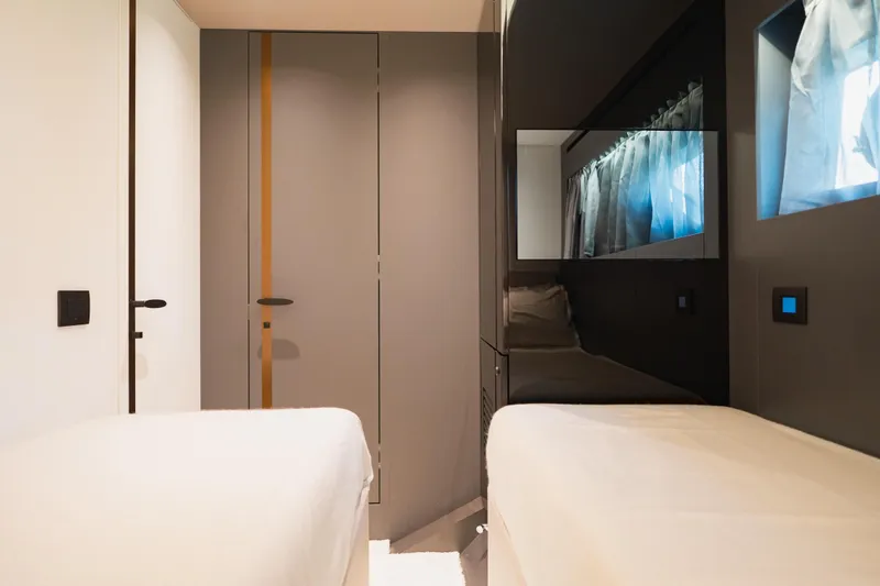 Explocean 3 Yacht Photos Pics Modern interior of 2025 Explorer 62 yacht with sleek design and cozy sleeping area.