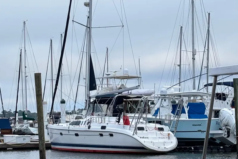 Kraken Yacht Photos Pics 2000 Hunter Passage 450 sailboat docked at a marina with other vessels.