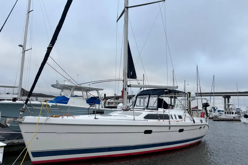 Kraken Yacht Photos Pics 2000 Hunter Passage 450 sailboat docked in marina, overcast sky, bridge in background.