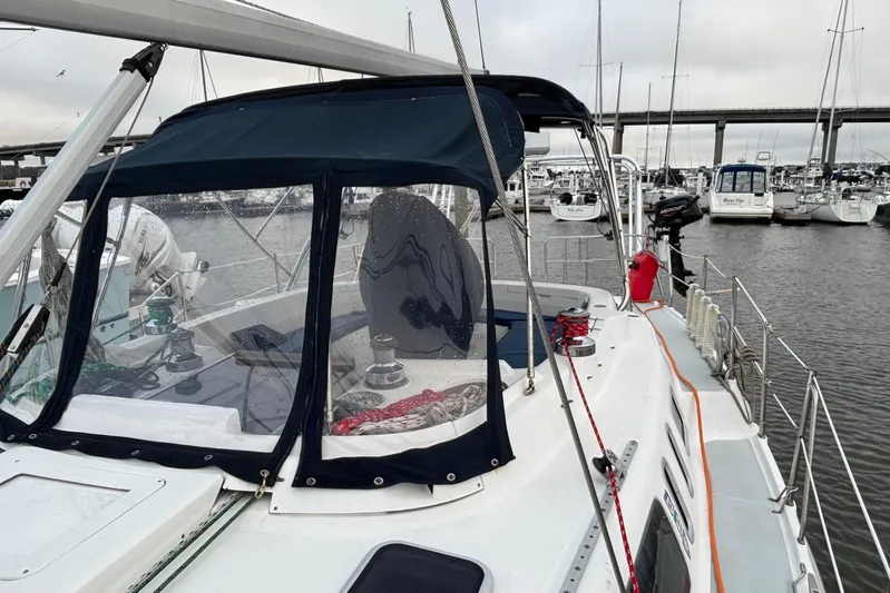 Kraken Yacht Photos Pics Sailboat Hunter Passage 450, 2000 model, docked in marina with protective canopy.