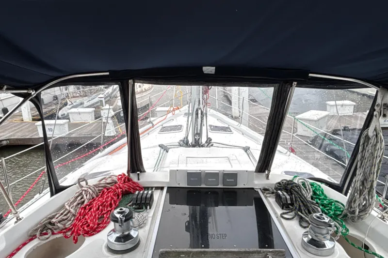 Kraken Yacht Photos Pics Cockpit view of 2000 Hunter Passage 450 sailboat with ropes and marina background.