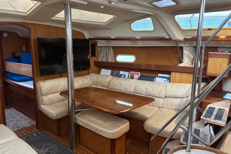 Kraken Yacht Photos Pics Interior of 2000 Hunter Passage 450 yacht with cozy seating and wooden finishes.