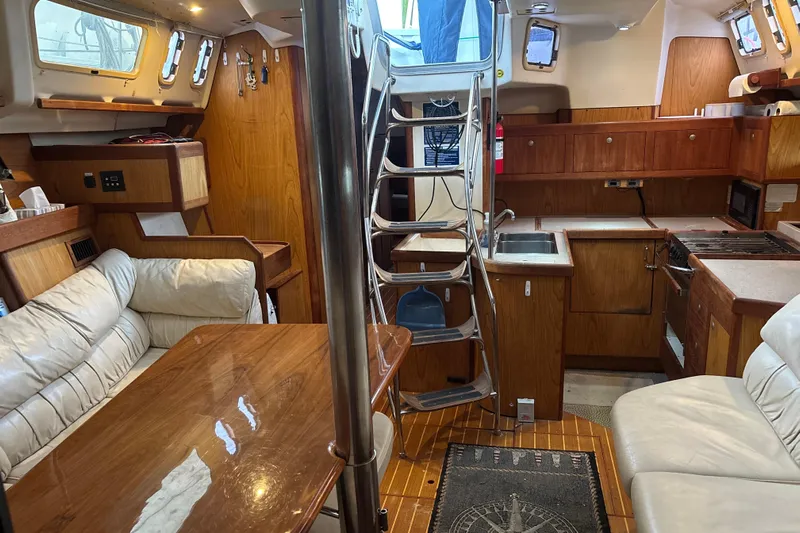 Kraken Yacht Photos Pics Interior of 2000 Hunter Passage 450 sailboat with wood finish and cozy seating area.