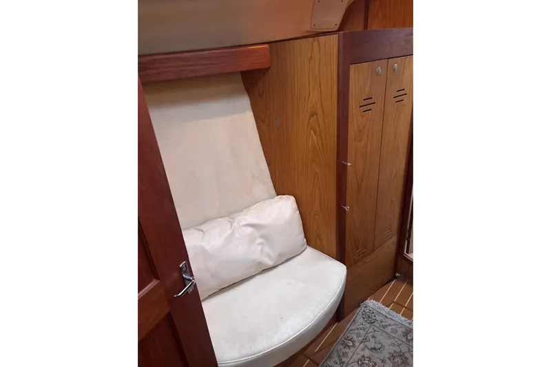 Kraken Yacht Photos Pics Interior of 2000 Hunter Passage 450 yacht with wooden paneling and cushioned seating.