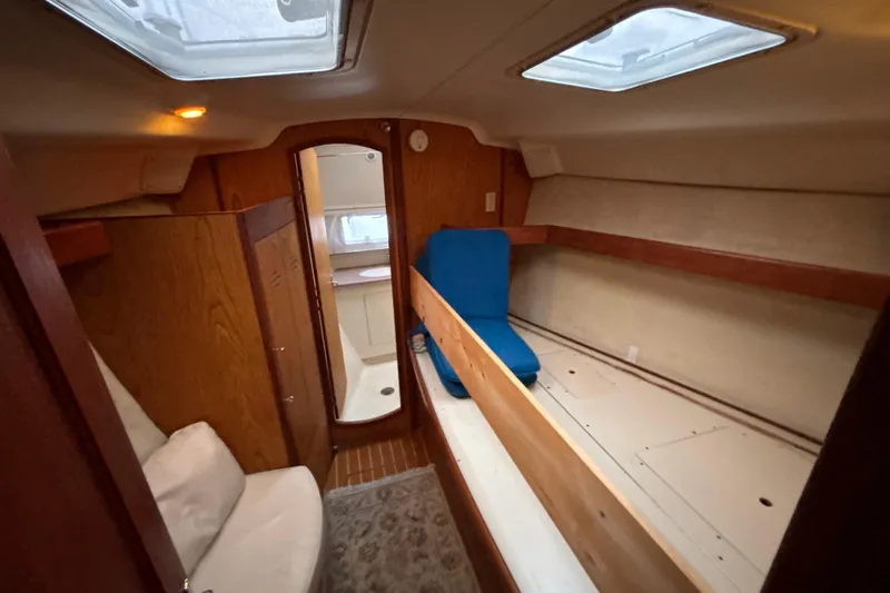 Kraken Yacht Photos Pics Interior of 2000 Hunter Passage 450 sailboat, featuring cozy cabin and wooden finishes.