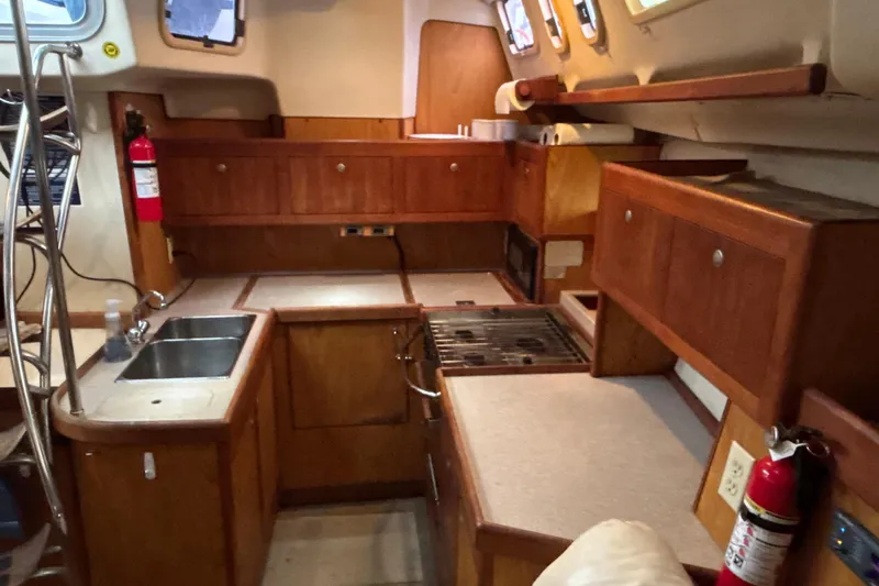 Kraken Yacht Photos Pics Interior of 2000 Hunter Passage 450 yacht kitchen with wooden cabinetry and appliances.
