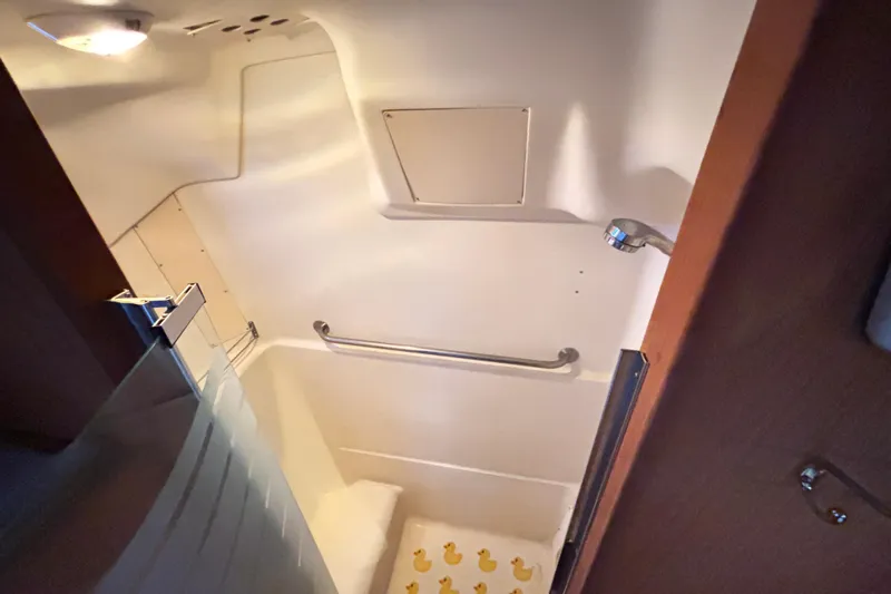 Kraken Yacht Photos Pics Interior shower of 2000 Hunter Passage 450 yacht with grab bar and rubber ducky mat.