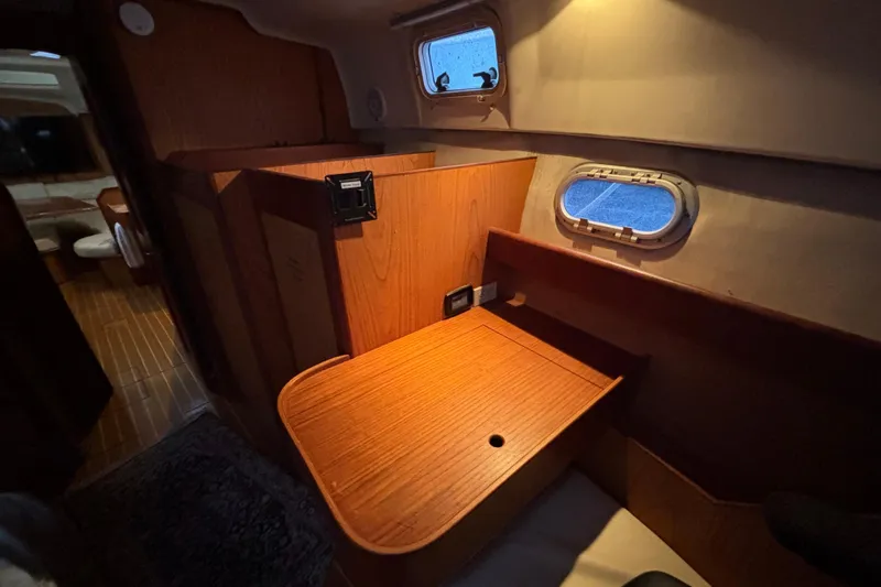 Kraken Yacht Photos Pics Interior of 2000 Hunter Passage 450 yacht with wooden cabinetry and porthole window.