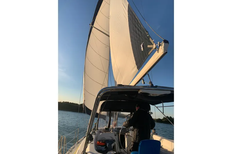 Kraken Yacht Photos Pics Sailing on a 2000 Hunter Passage 450 yacht at sunset, with full sails.