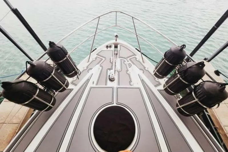  Yacht Photos Pics Bow of 2007 Regal Commodore 4460 yacht with fenders, docked on calm water.