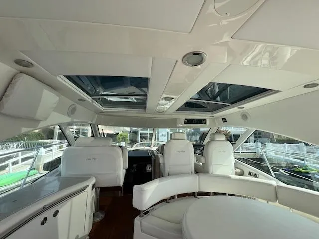 Obsession Yacht Photos Pics Interior of 2008 Sea Ray 55 Sundancer yacht with white seating and panoramic windows.