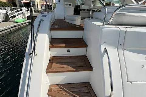 Obsession Yacht Photos Pics Staircase on 2008 Sea Ray 55 Sundancer yacht, featuring wooden steps and white railing.