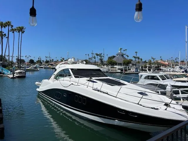 Obsession Yacht Photos Pics 2008 Sea Ray 55 Sundancer yacht docked in a sunny marina.