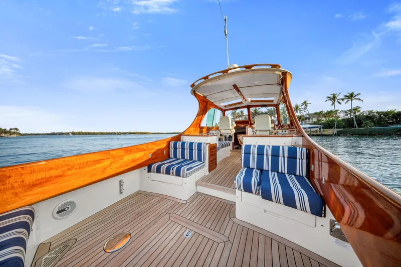 Midnight Yacht Photos Pics 2014 Hinckley Picnic Boat 37 MKIII with elegant wood finish and striped seating on open water.
