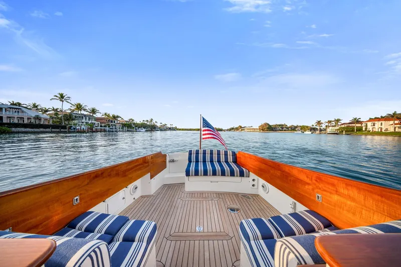 Midnight Yacht Photos Pics Hinckley Picnic Boat 37 MKIII, 2014, with striped seating, cruising on a scenic waterway.