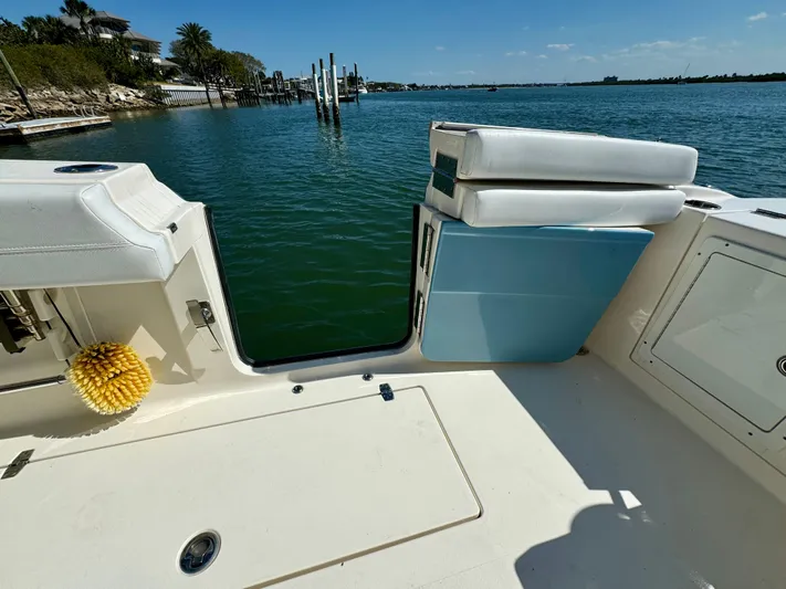  Yacht Photos Pics 2020 Cobia 350 Center Console boat with open deck, docked by calm waters.