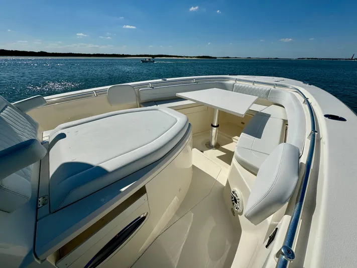  Yacht Photos Pics 2020 Cobia 350 Center Console boat interior with seating and table on a sunny day.