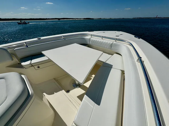  Yacht Photos Pics 2020 Cobia 350 Center Console boat with seating and table on calm water.