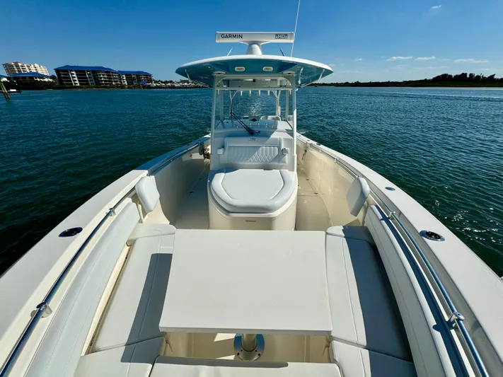  Yacht Photos Pics 2020 Cobia 350 Center Console boat on calm water, featuring spacious deck and seating.