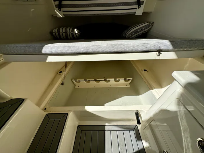  Yacht Photos Pics 2020 Cobia 350 Center Console interior with cushioned seating and storage space.