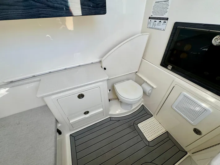  Yacht Photos Pics 2020 Cobia 350 Center Console boat interior with toilet and storage compartments.