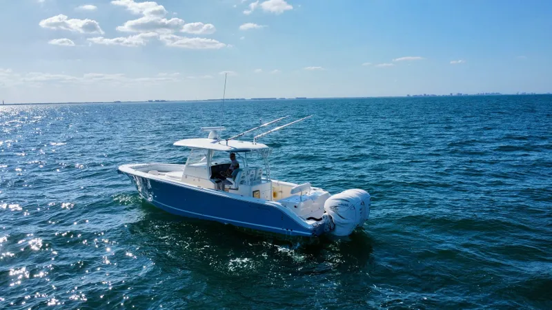  Yacht Photos Pics 2020 Cobia 350 Center Console boat cruising on open water under a clear blue sky.