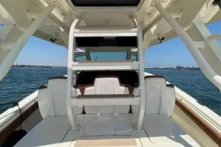  Yacht Photos Pics 2019 Scout 420 LXF boat interior with seating, ocean view, and clear sky.