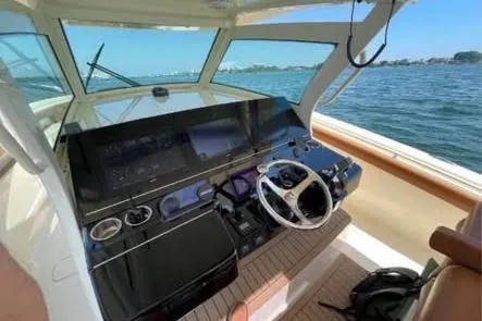  Yacht Photos Pics 2019 Scout 420 LXF boat cockpit with modern controls and ocean view.