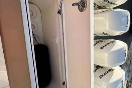  Yacht Photos Pics 2019 Scout 420 LXF boat with open storage compartment and multiple outboard engines.