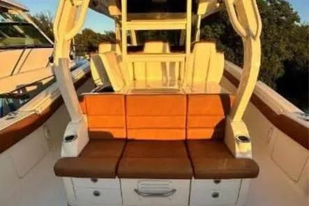  Yacht Photos Pics 2019 Scout 420 LXF boat interior with orange seating and modern design.