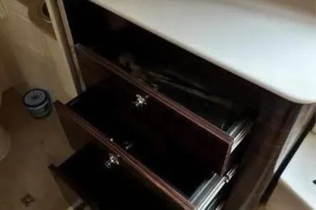  Yacht Photos Pics Open wooden drawers inside a 2019 Scout 420 LXF boat interior.