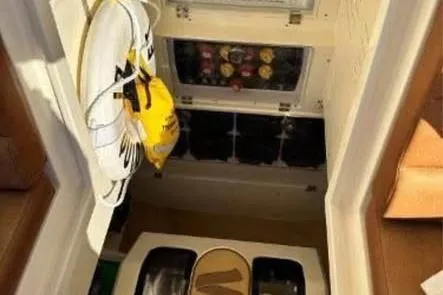  Yacht Photos Pics Interior view of 2019 Scout 420 LXF boat with life jackets and storage compartments.