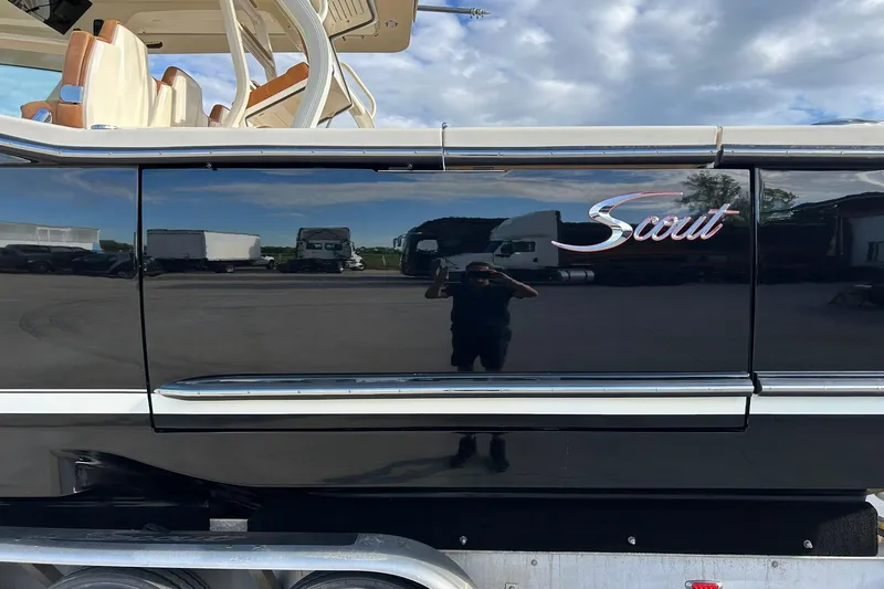  Yacht Photos Pics 2019 Scout 420 LXF boat side view with logo, reflecting surroundings.