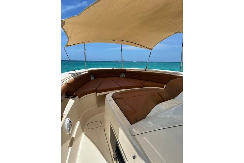  Yacht Photos Pics Luxurious 2019 Scout 420 LXF boat interior with sunshade, overlooking turquoise ocean waters.
