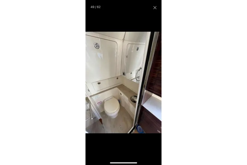  Yacht Photos Pics 2019 Scout 420 LXF boat bathroom interior with toilet and sink.