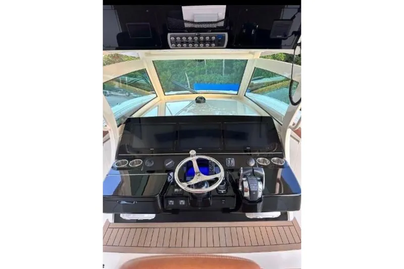 Yacht Photos Pics 2019 Scout 420 LXF boat helm with steering wheel and control panel.