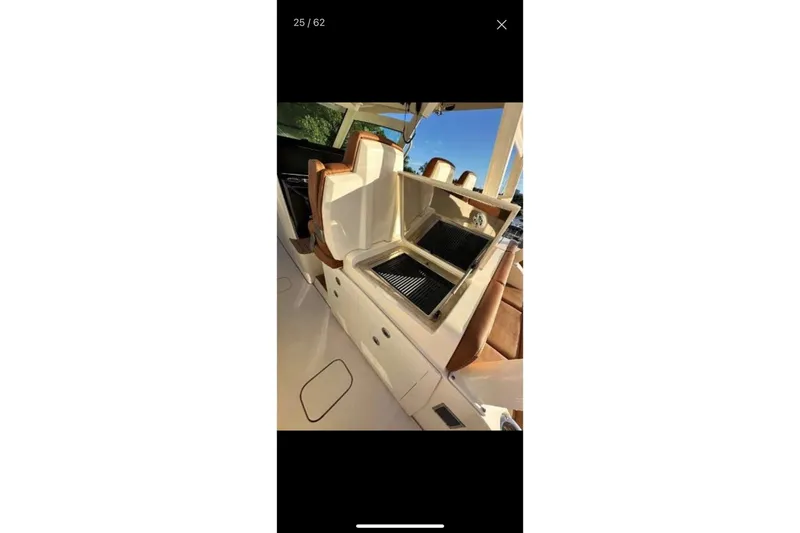  Yacht Photos Pics 2019 Scout 420 LXF boat with open grill and seating area.