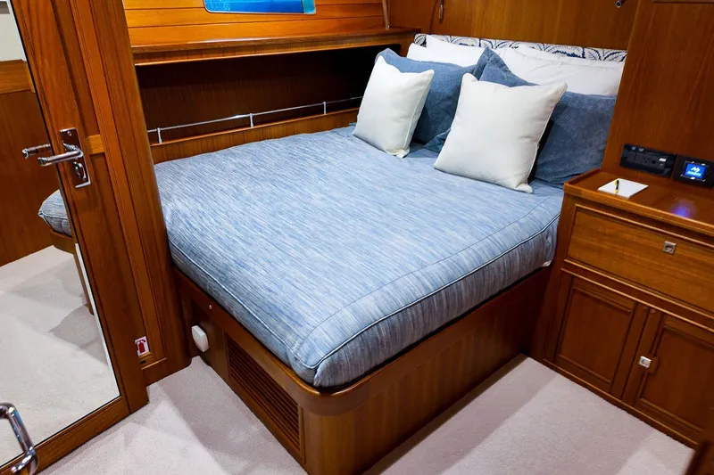 Top Times Yacht Photos Pics Luxurious cabin interior of 2022 Marlow Voyager Series yacht with cozy bed and wooden furnishings.
