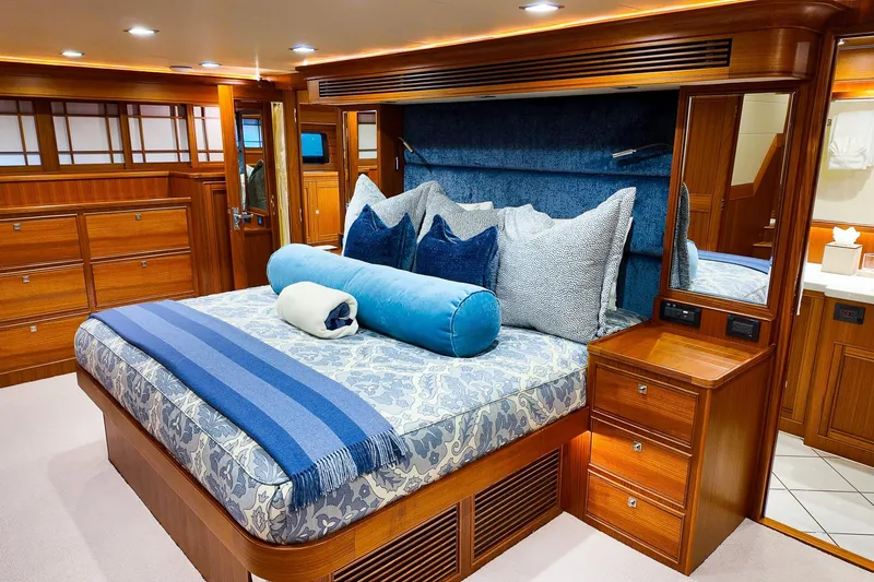Top Times Yacht Photos Pics Luxurious Marlow Voyager Series 2022 yacht bedroom with elegant wood finish and plush bedding.