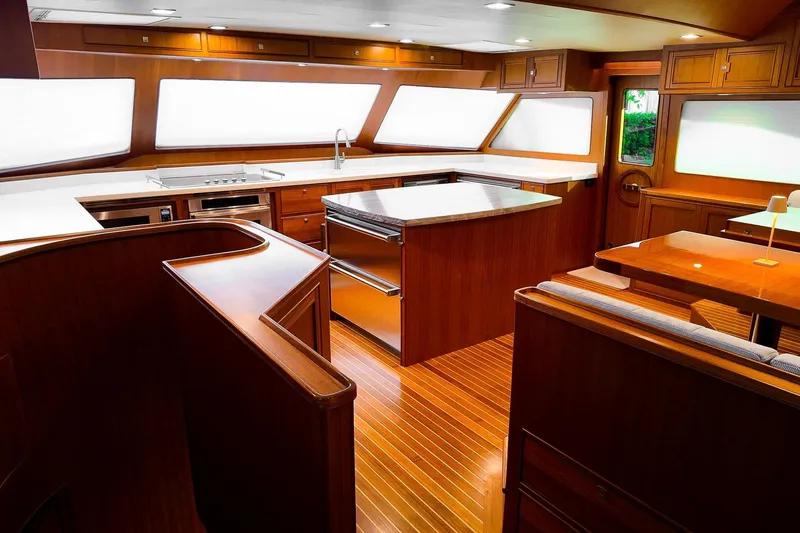 Top Times Yacht Photos Pics Luxurious 2022 Marlow Voyager Series yacht interior with modern kitchen and dining area.