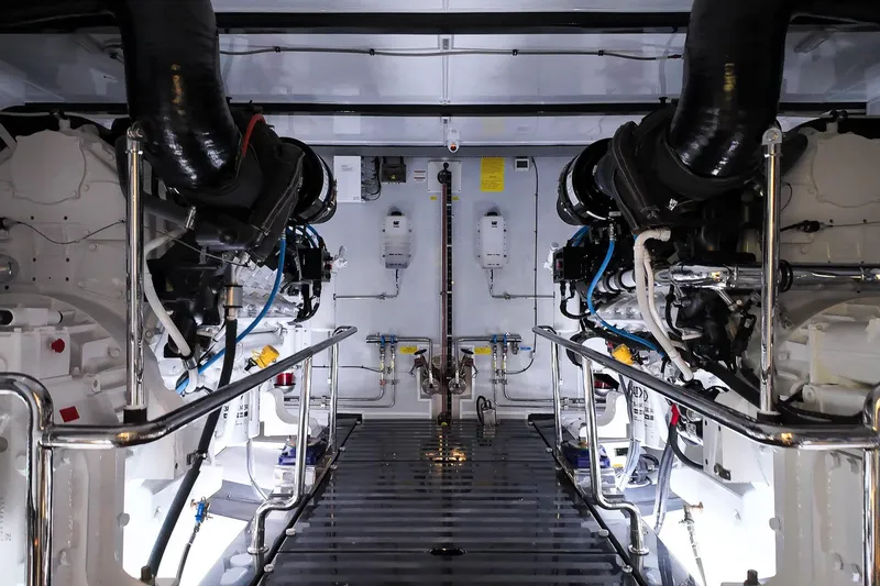 Top Times Yacht Photos Pics Engine room of 2022 Marlow Voyager Series yacht, featuring advanced machinery and piping systems.