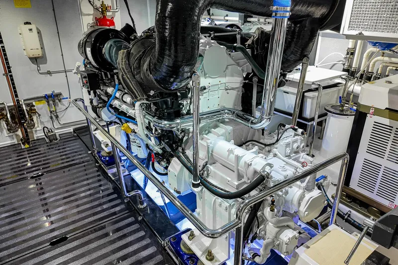 Top Times Yacht Photos Pics Engine room of 2022 Marlow Voyager Series yacht, showcasing advanced machinery and piping.