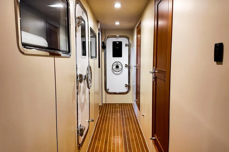 Top Times Yacht Photos Pics Interior hallway of 2022 Marlow Voyager Series yacht with wooden flooring and secure doors.