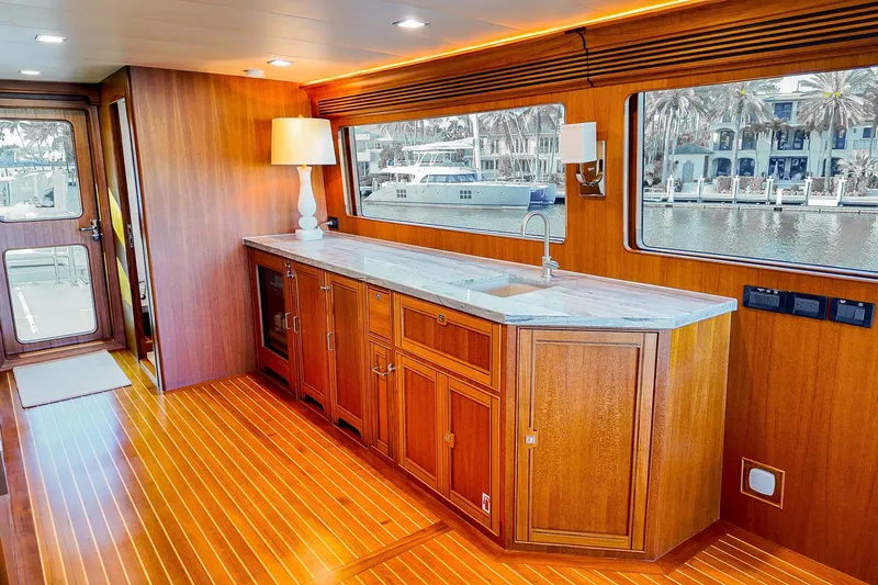 Top Times Yacht Photos Pics Luxurious 2022 Marlow Voyager yacht interior with elegant wood cabinetry and waterfront view.