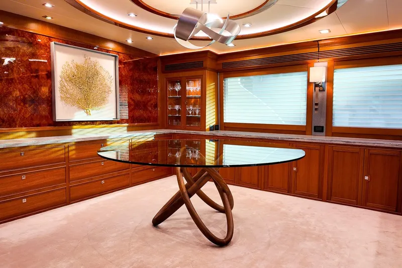 Top Times Yacht Photos Pics Luxurious Marlow Voyager Series 2022 yacht interior with elegant glass table and wood accents.
